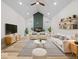 Tastefully designed living room with modern furniture, vaulted ceilings, and hardwood floors at 31 Mckenzie St, Shelbyville, IN 46176