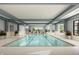 Inviting indoor pool area with ample space for relaxation and recreation, with large windows at 3142 Balsamroot Rd, Greenwood, IN 46143