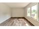Sunny bedroom with wood-look floors and ample natural light through large windows at 3242 Welch Dr, Indianapolis, IN 46224