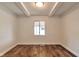 Bright bedroom with wood flooring, white walls, ceiling beams, and a window at 3242 Welch Dr, Indianapolis, IN 46224
