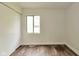 Bright bedroom featuring sliding closet doors, wood flooring and a window at 3242 Welch Dr, Indianapolis, IN 46224