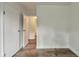 Bedroom with wood flooring and white walls leading to an open doorway at 3242 Welch Dr, Indianapolis, IN 46224