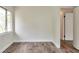 Cozy bedroom showing wood-look floors, and a large window at 3242 Welch Dr, Indianapolis, IN 46224