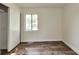 Clean bedroom featuring wood-look flooring, closet, and a bright window at 3242 Welch Dr, Indianapolis, IN 46224