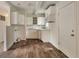 Functional kitchen with white cabinets, brick backsplash, and vinyl flooring at 3242 Welch Dr, Indianapolis, IN 46224