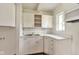 Efficient kitchen space with white cabinets, a brick backsplash, and modern sink at 3242 Welch Dr, Indianapolis, IN 46224