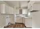 Practical kitchen featuring white cabinets, a microwave, and wood-look flooring at 3242 Welch Dr, Indianapolis, IN 46224