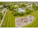 Aerial view showcasing a community pool, playground, and surrounding neighborhood with lush green spaces at 3876 Kegler Way, Carmel, IN 46074