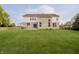Expansive backyard with lush lawn, patio dining area, and well-maintained fencing for privacy at 3876 Kegler Way, Carmel, IN 46074