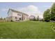 Lush green backyard with a patio set, privacy fence, and a view of the home's rear exterior at 3876 Kegler Way, Carmel, IN 46074