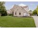 Charming two-story home with brick facade, landscaped front yard, and attached three-car garage at 3876 Kegler Way, Carmel, IN 46074