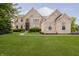 Stunning two-story brick home with manicured lawn, professional landscaping, and basketball hoop at 3876 Kegler Way, Carmel, IN 46074