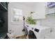 Laundry room with front-loading machines, storage and natural light at 3876 Kegler Way, Carmel, IN 46074