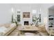 Open living room with fireplace, wood floors, large windows, and stylish decor at 3876 Kegler Way, Carmel, IN 46074