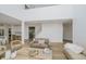 Open-concept living room with wood floors, neutral furniture, and view to staircase and kitchen at 3876 Kegler Way, Carmel, IN 46074