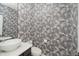 Stylish powder room with unique wallpaper, modern vanity and fixtures, plus a decorative mirror at 3876 Kegler Way, Carmel, IN 46074