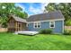 Charming backyard featuring a screened in porch, patio and lush green lawn at 3940 E 57Th St, Indianapolis, IN 46220