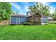 Charming backyard featuring a screened in porch, shed and lush green lawn at 3940 E 57Th St, Indianapolis, IN 46220
