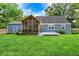Charming backyard featuring a screened in porch, patio and lush green lawn at 3940 E 57Th St, Indianapolis, IN 46220