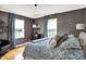 Bedroom featuring wood floors, blue curtains, and decorative lamp at 3940 E 57Th St, Indianapolis, IN 46220