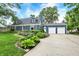 Landscaped front yard and a two-car garage enhance this home's curb appeal at 3940 E 57Th St, Indianapolis, IN 46220