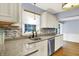 Bright kitchen featuring granite countertops, tile backsplash, and stainless steel appliances at 3940 E 57Th St, Indianapolis, IN 46220