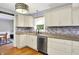 Well-lit kitchen featuring white cabinets, stainless steel appliances, and tiled backsplash at 3940 E 57Th St, Indianapolis, IN 46220