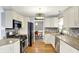 Kitchen featuring stainless steel appliances, granite counters, and a view to the dining room at 3940 E 57Th St, Indianapolis, IN 46220