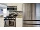 Kitchen details showcasing gas range, stainless steel refrigerator, and tiled backsplash at 3940 E 57Th St, Indianapolis, IN 46220