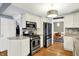 Modern kitchen with stainless steel appliances, white cabinetry, and granite countertops at 3940 E 57Th St, Indianapolis, IN 46220