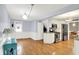 Open kitchen with stainless steel appliances and hardwood floors connecting to a dining area at 3940 E 57Th St, Indianapolis, IN 46220