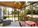 Inviting screened porch overlooking a green lawn and fenced in backyard at 3940 E 57Th St, Indianapolis, IN 46220