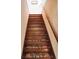 Beautiful wooden staircase with carpeted steps and handrail at 3940 E 57Th St, Indianapolis, IN 46220