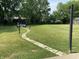 Expansive backyard with a stone pathway leading to a shaded bench, creating a serene outdoor space at 4343 W Fairview Rd, Greenwood, IN 46142
