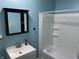 Bright bathroom featuring a shower-tub combo, updated vanity, and stylish fixtures at 4343 W Fairview Rd, Greenwood, IN 46142