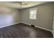 Bedroom with vinyl floors, a window, and neutral wall colors at 4343 W Fairview Rd, Greenwood, IN 46142