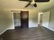 Bedroom features wood-look floors, ceiling fan and large closet with rustic sliding barn door at 4343 W Fairview Rd, Greenwood, IN 46142