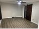 Bedroom featuring wood-look floors, a ceiling fan, and a barn door closet at 4343 W Fairview Rd, Greenwood, IN 46142
