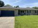 Charming single-story home with a brick facade, blue garage door, and well-manicured lawn at 4343 W Fairview Rd, Greenwood, IN 46142