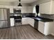Modern kitchen with stainless steel appliances, black countertops, and ample cabinet space at 4343 W Fairview Rd, Greenwood, IN 46142