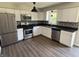 Modern kitchen featuring stainless steel appliances, white cabinets, and a stylish backsplash at 4343 W Fairview Rd, Greenwood, IN 46142