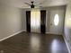 Inviting living room featuring wood-look floors, a ceiling fan, and a bright front door at 4343 W Fairview Rd, Greenwood, IN 46142