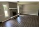 Cozy living room featuring a brick fireplace, vinyl flooring, and bright windows at 4343 W Fairview Rd, Greenwood, IN 46142