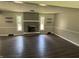 Open living room with vinyl flooring and a cozy fireplace as a focal point at 4343 W Fairview Rd, Greenwood, IN 46142