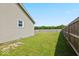 Side yard with a fenced perimeter and ample green space at 4605 Clairmont Dr, Columbus, IN 47203