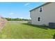 Fenced backyard featuring green grass and a view of the home, perfect for outdoor enjoyment at 4605 Clairmont Dr, Columbus, IN 47203