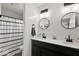 Modern bathroom featuring dual sinks, black fixtures, and round mirrors for a contemporary design at 4605 Clairmont Dr, Columbus, IN 47203