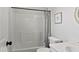 Bright bathroom featuring a shower and bathtub with gray curtains and white sink and toilet at 4605 Clairmont Dr, Columbus, IN 47203