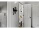A clean white half-bathroom with a modern toilet, and a shelf with keyhooks is featured at 4605 Clairmont Dr, Columbus, IN 47203