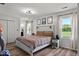 Bright bedroom with wood-look floors, white trim, a queen bed, and a closet at 4605 Clairmont Dr, Columbus, IN 47203